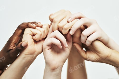 Preview: Holding on together. Shot of a group of hands holding onto each other against a white background.