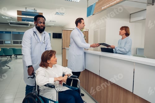 Preview: Doctor and nurse taking care and talking mature female patient.