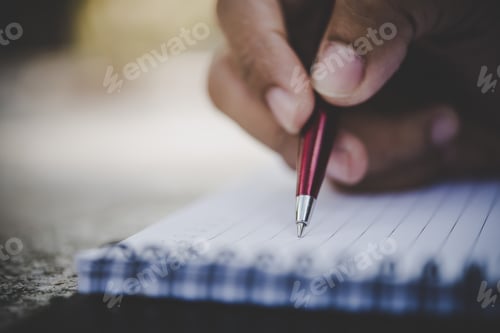 Preview: Man hand writing on his notebook.