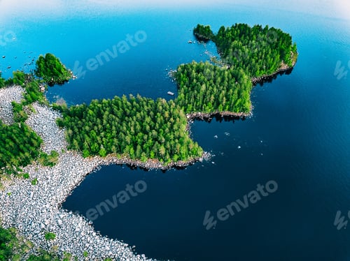 Preview: Tranquil Aerial View of Lush Green Forest Islands Surrounded by Serene Blue Waters