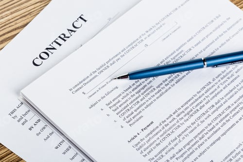 Preview: Pen and contract papers on wooden desk
