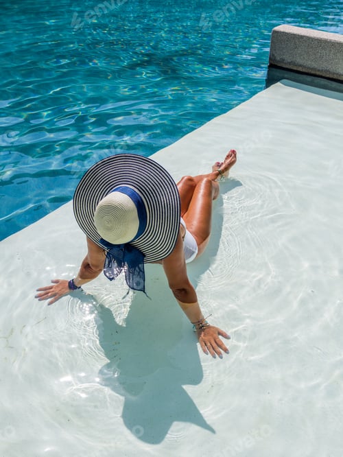 Preview: woman in luxury spa resort near the swimming pool.