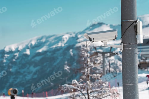 Preview: Surveillance camera monitoring ski slope with snowy mountains in background. In Folgarida