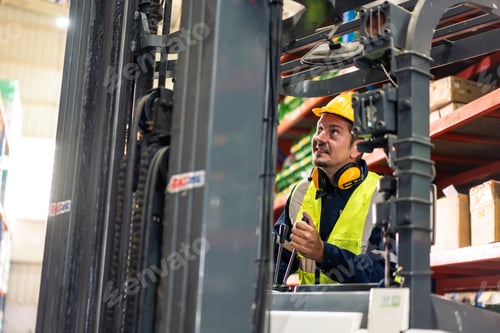 Preview: Caucasian attractive man industrial worker work in manufacturing plant.