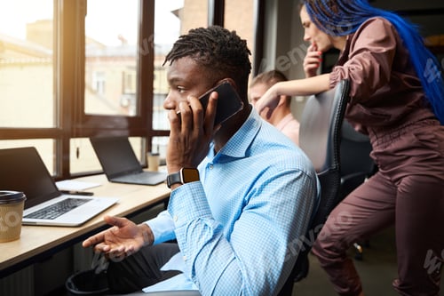 Preview: Busy African American man talking phone, trying to find problem solution