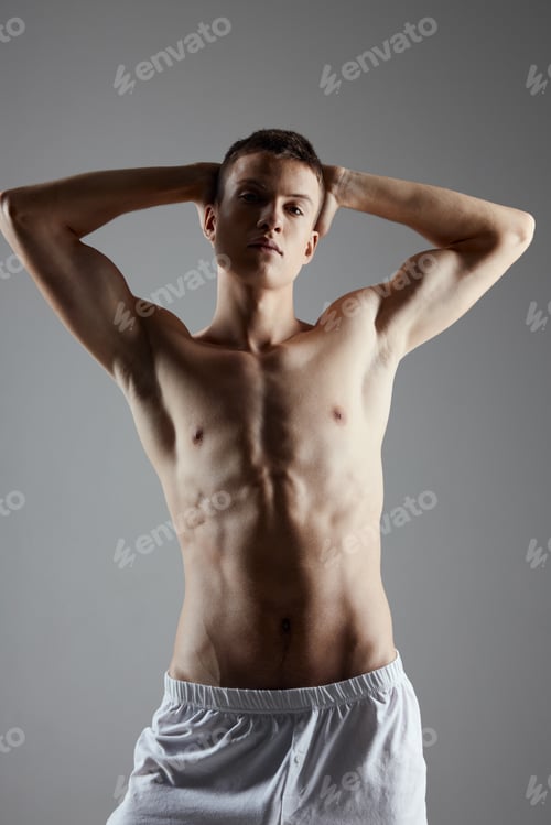 Preview: man with a pumped up torso holds his hands behind his head fitness workout