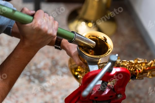 Preview: Luthier repairing saxophone bell with specialized tool