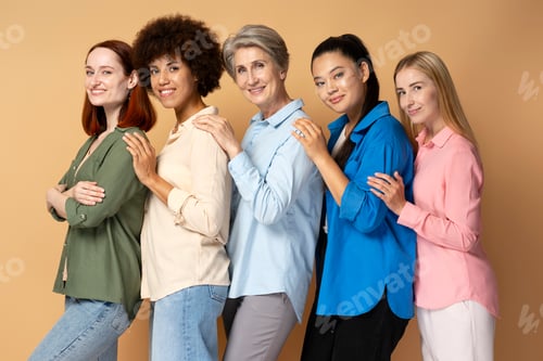 Preview: Beautiful smiling multiracial women wearing stylish colorful shirts, hugging each other