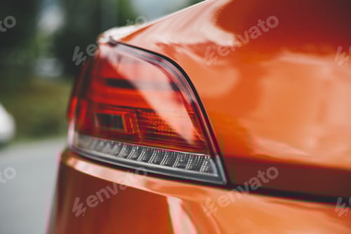 Preview: Selective closeup shot of a red car taillight with a blurry background