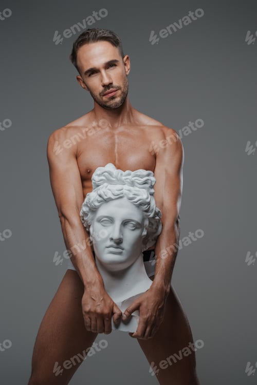 Preview: An attractive male model, dressed only in underwear on a gray backdrop