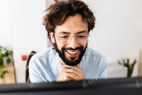 Preview: Successful freelancer smiling while having a video call on laptop at home