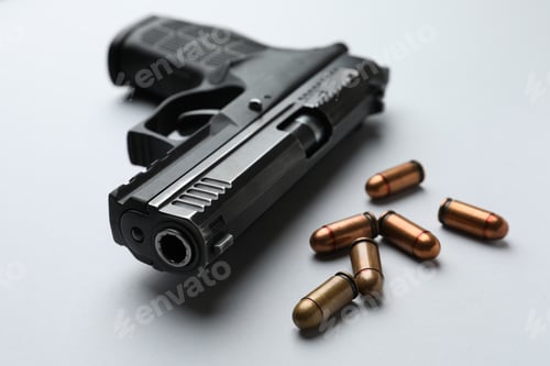 Preview: Semi-automatic pistol and bullets on light background, closeup