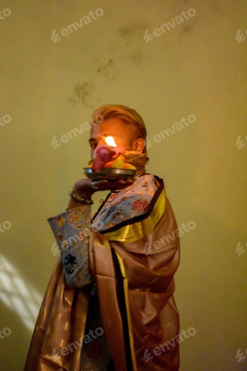 Preview: Man standing and holding a candle