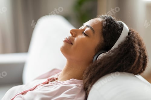 Preview: Serene African American woman resting on couch