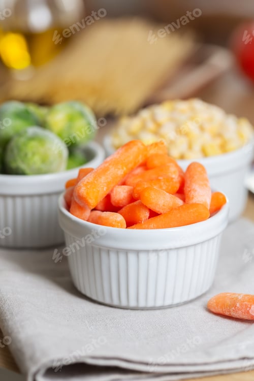 Preview: Frozen vegetables such as baby carrot and and Brussels sprouts in the bowls on the kitchen table