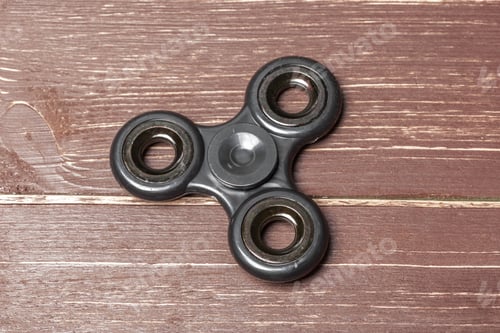Preview: spinner on a wooden table. close up