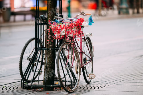 Preview: Female Bicycle Equipped Basket With Decorative Flowers Parked In