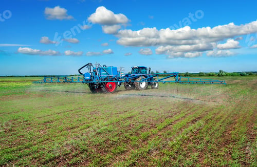 Preview: tractor in field work with trailed sprayer