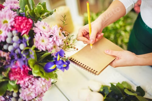 Floral Designer with Flowers Taking Notes