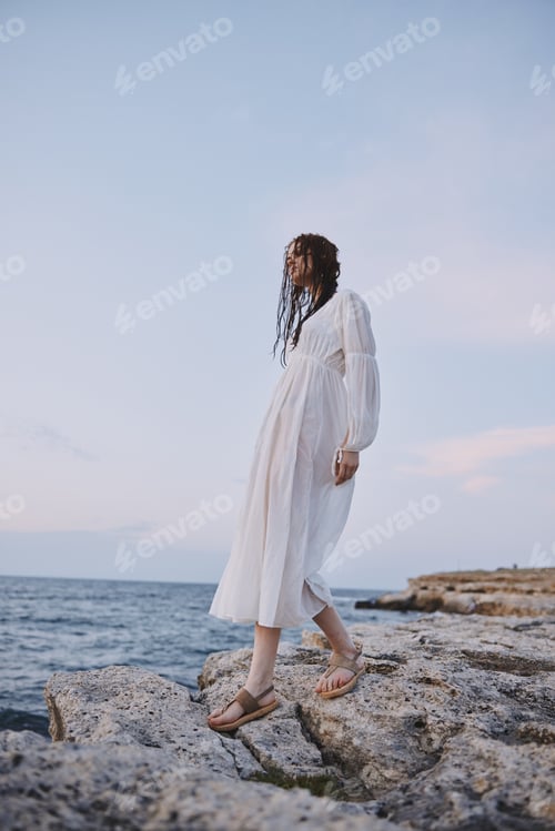Preview: Beautiful woman in white dress at the sea beach Lifestyle