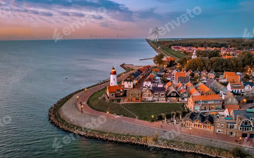 Preview: Urk Flevoland Netherlands sunset at the lighthouse and harbor of Urk Holland. Fishing village Urk