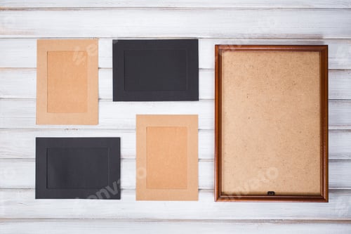 Preview: picture frames of different colors and wooden background