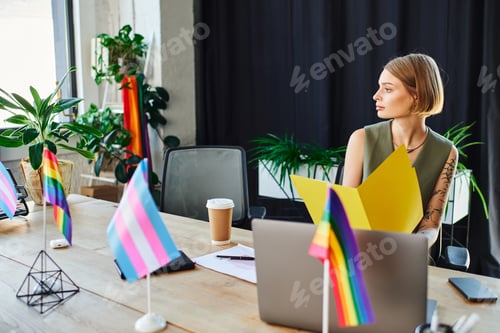 Preview: Coworkers gather in an inclusive office space adorned with pride flags and vibrant decorations