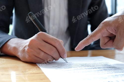 Preview: People hand pointing to sign documents.