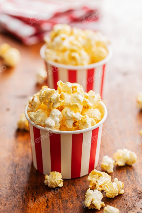 Preview: Sweet tasty popcorn in striped paper cup.