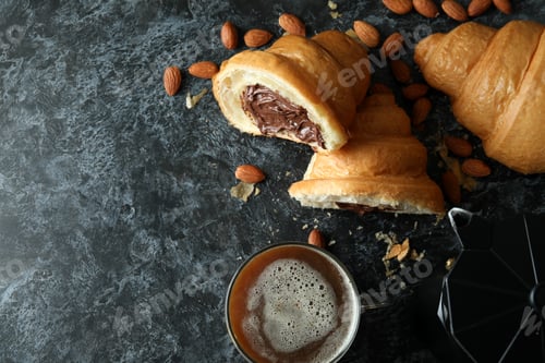 Preview: Concept of tasty breakfast with croissant with chocolate on dark background