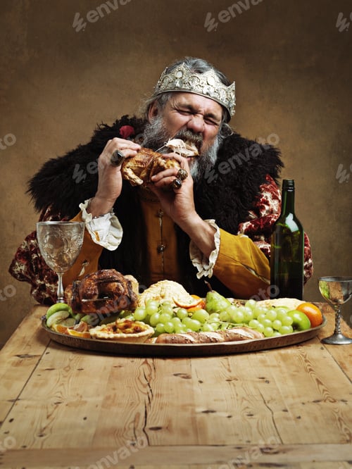 Preview: Ruling is hungry business. A mature king feasting alone in a banquet hall.