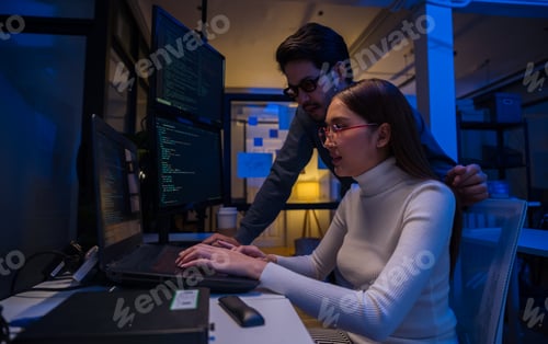 Preview: Young Asian business people working late into the night in the office,