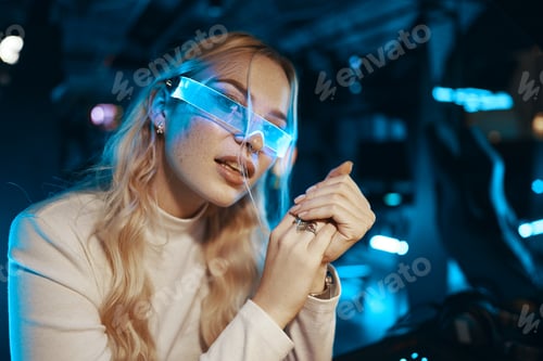 Preview: Cute blonde in futuristic fashion style. Neon glasses for a young woman.