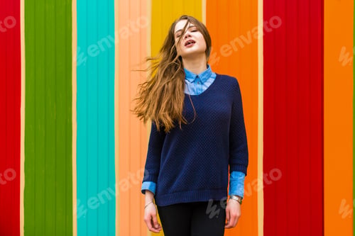 Preview: Very beautiful girl on a background of colorful wall