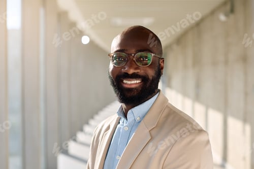 Preview: Portrait of happy black businessman looking at camera.