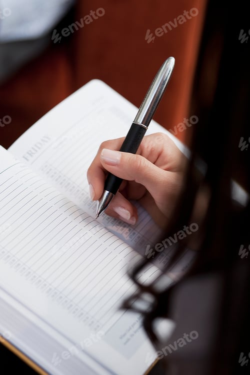 Preview: Close up of secretary making notes at meeting