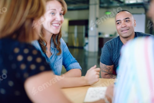 Preview: Unposed group of creative business people in an open concept off