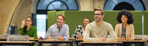 Preview: Group of multiracial business people sitting in the modern office and listening to coach or