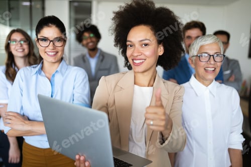 Preview: Happy business people celebrating success at company