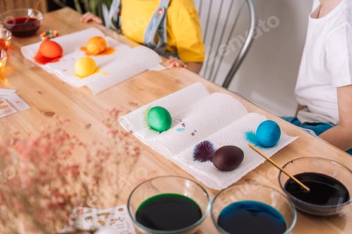 Preview: Children preparing for Easter paint eggs in different colors