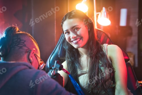 Preview: Artist Drawing Tattoo On Client In Parlor