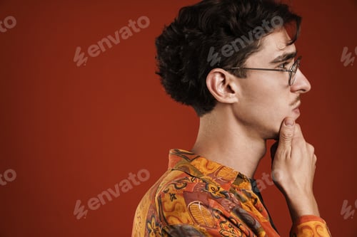 Preview: Pensive young hipster teenager in glasses isolated