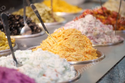 Preview: Colorful variety of salads and side dishes displayed in a buffet