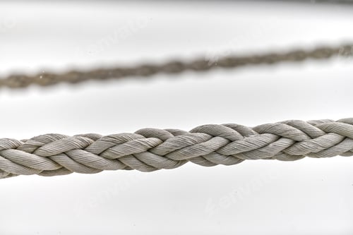 Preview: Two sail ropes hanging from fishing ship or yacht, close up