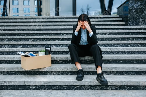 Preview: Depressed Woman Holding Cardboard Box on Stairs