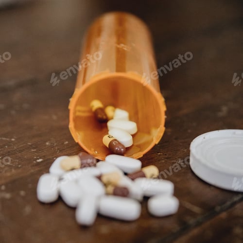 Preview: Prescription drugs spill out onto an old wooden table