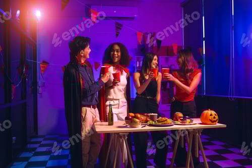 Preview: Asian friends, middle-aged man and young woman, enjoy Halloween office party with vampire costumes