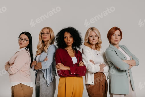 Preview: Multi-ethnic group of confident mature women looking at camera against grey background