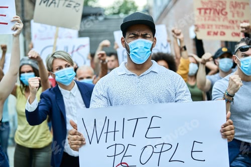 Preview: Black man with protective face mask participating in demonstrations against racism.