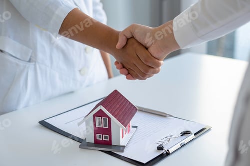 Preview: Successful deal Real estate lease or home purchase concept buyer shakes hands with bank employee aft